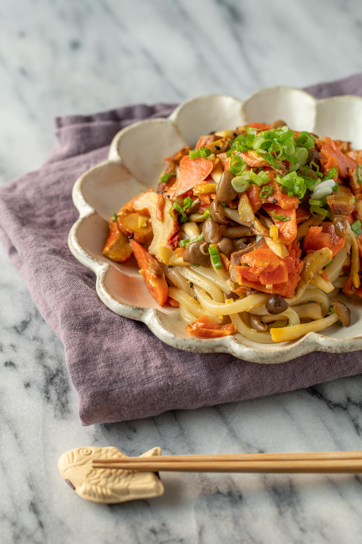stir fry udon with salmon and mushroom with chopsticks